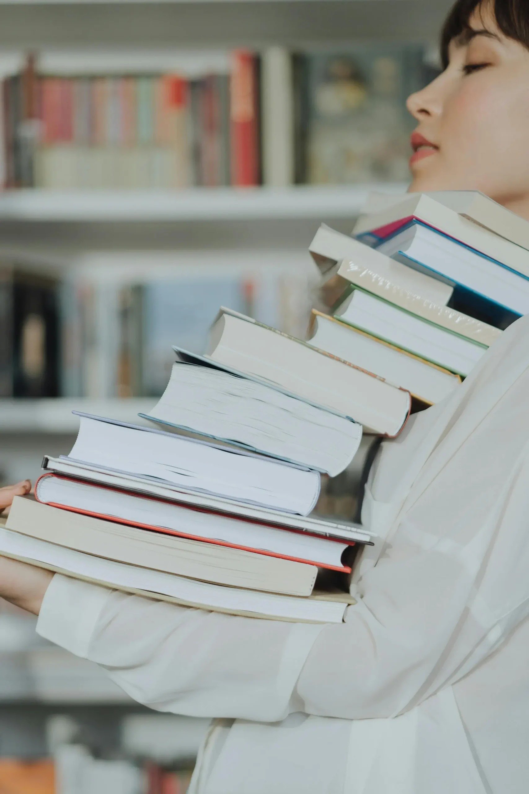 Woman carrying too many books